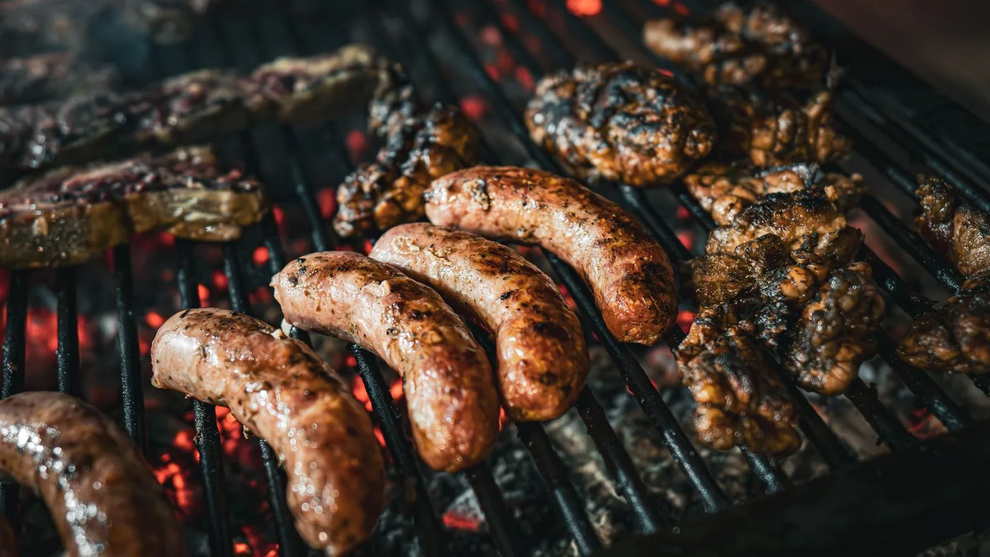 Salsicce e costine sulla griglia a carbone di una festa di paese.